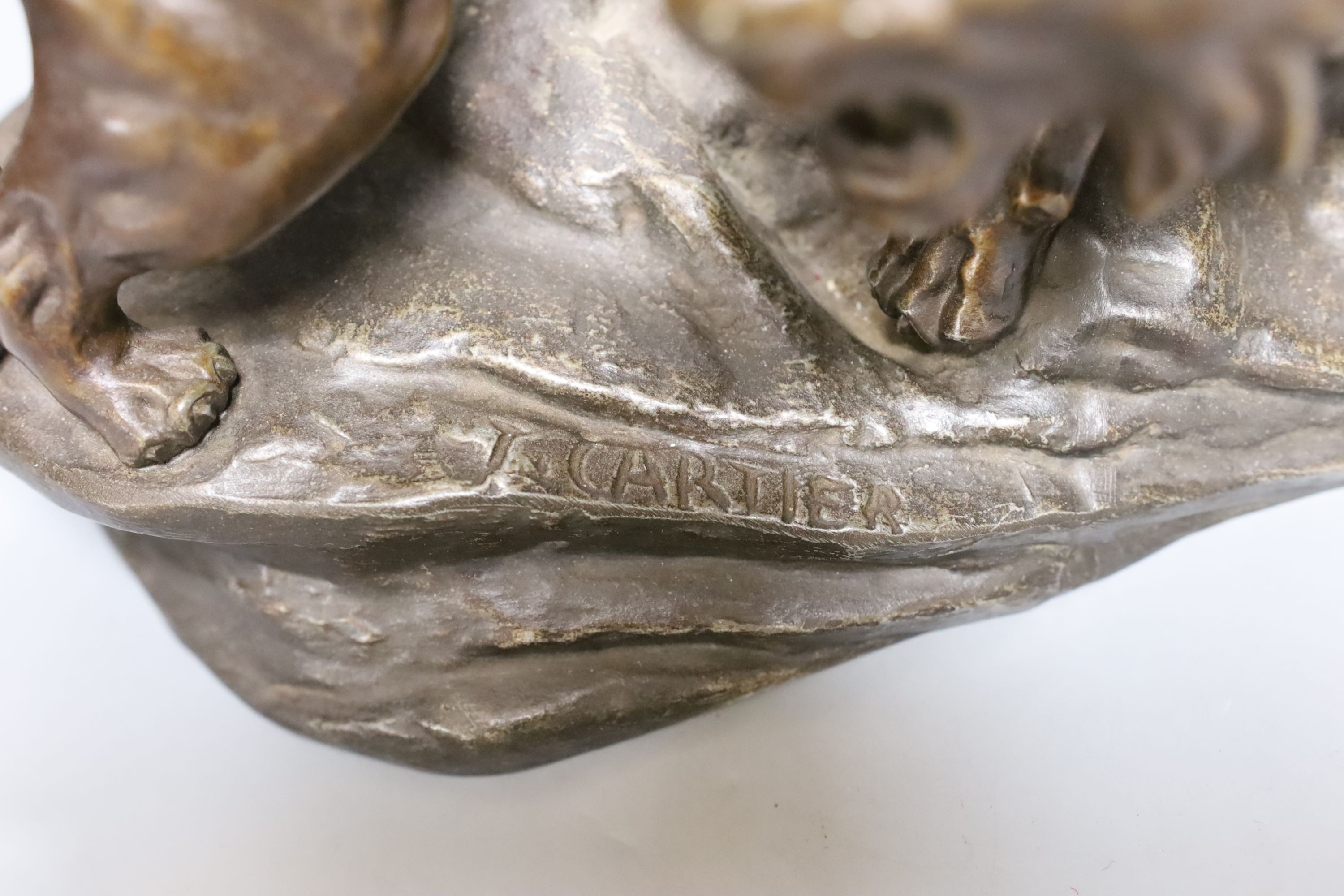 A patinated spelter group of a lion and lioness, 53 cms wide.